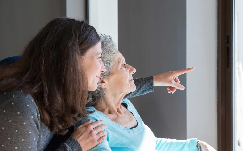 Person caring for elderly adult in home