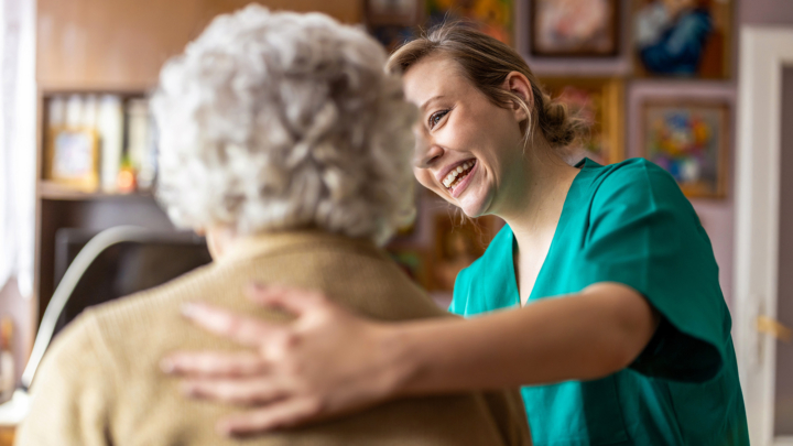 Smiling Nurse Talking To Assited Living Resident