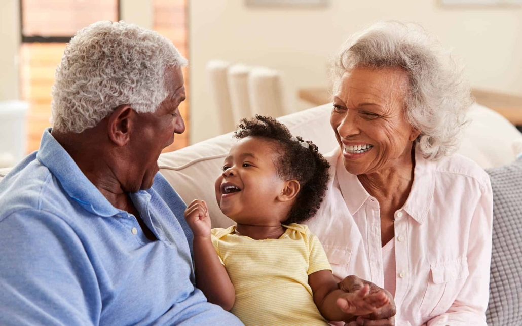 Two Grandparents With Their Grandchild