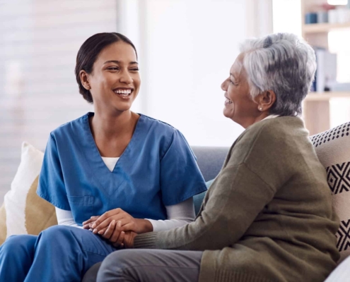 Caregiver With Senior Woman For Conversation