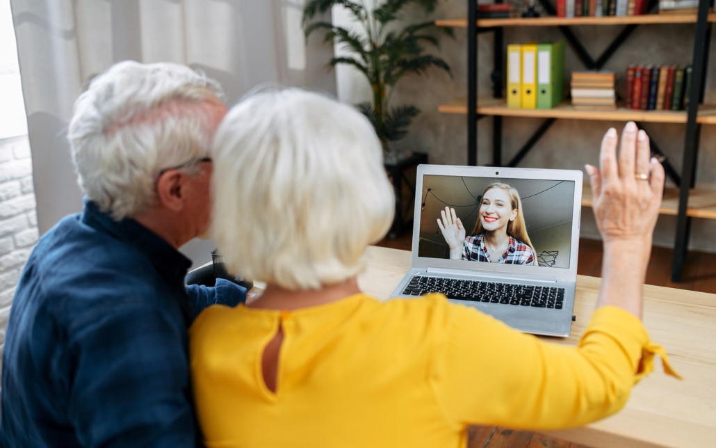 Elderly Couple Using Laptop To Have Video Call With Family