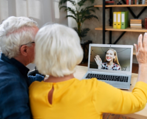 Elderly Couple Using Laptop To Have Video Call With Family