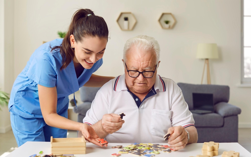 Caretaker Helping Dementia Patient With Puzzle