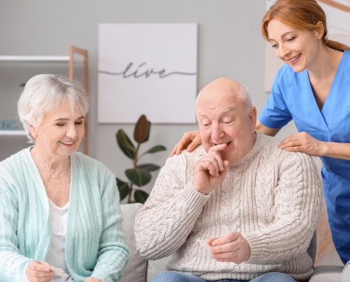 Caretaker Helping Older Couple With Memory Care