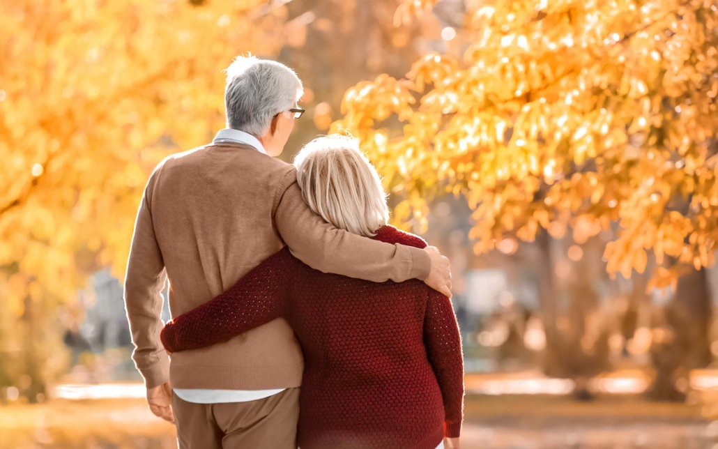 Cute Elderly Couple Walking In Autumn Park