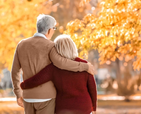 Cute Elderly Couple Walking In Autumn Park