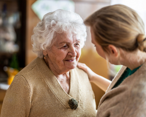 Person Talking With Their Elderly Parent