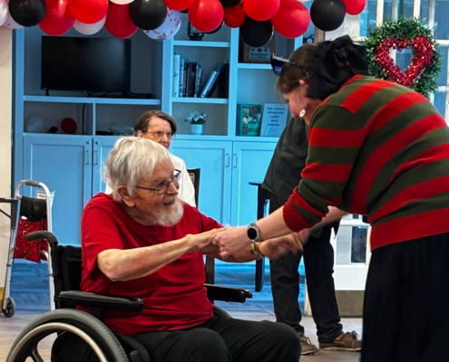 Caretaker Dancing With Loved One In Wheelchair For Valentines Day