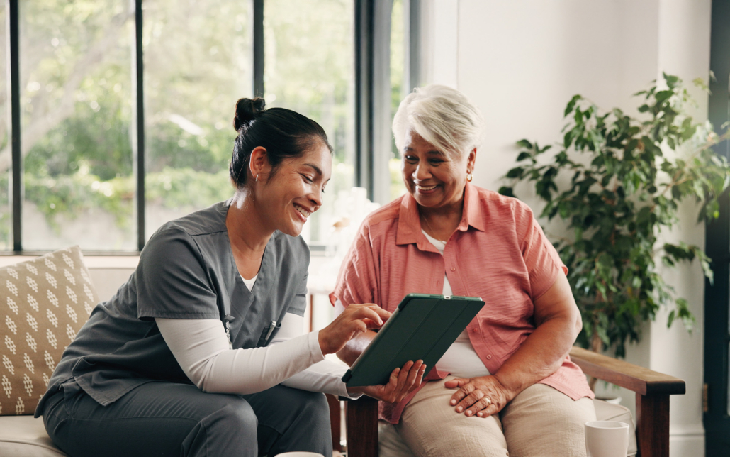 Medical, Tablet Or Talking With Nurse And Old Woman In Home Living Room