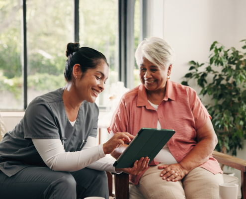 Medical, Tablet Or Talking With Nurse And Old Woman In Home Living Room